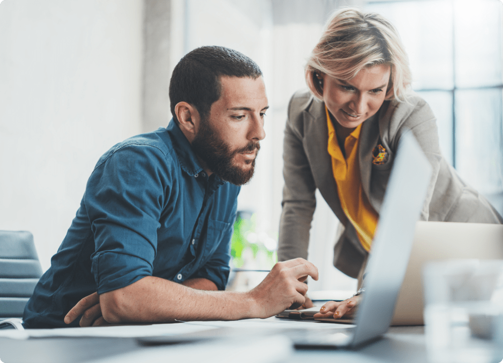 iStock-1162810399-Fintech-2-edited | Autoaddress Man using a laptop with a woman looking on, symbolizing collaborative fintech solutions enabled by our Address Verification technology