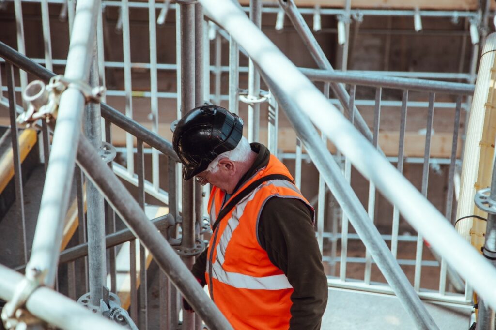 Construction worker on site, emphasizing the role of Eircodes in estimating housing demand through address capture and verification.