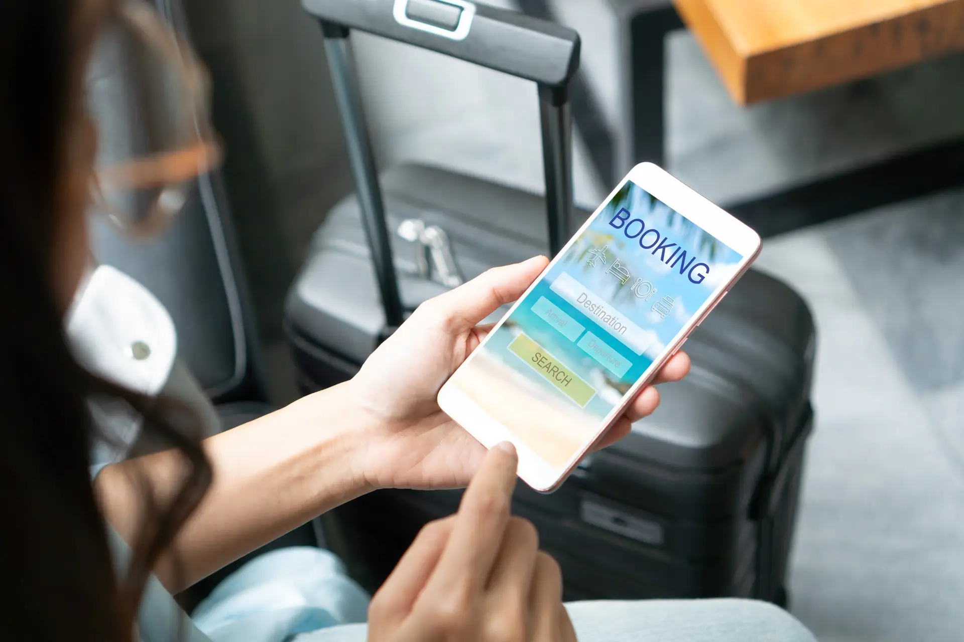 Woman search ticket reservation for holiday Girl using travel application for flight tickets and hotel room online booking Online travel agency hotel flight ticket booking travel planning concept | Autoaddress The image shows a person engrossed in using their smartphone, presumably booking a holiday through a travel agent. They appear focused and engaged, symbolizing the modern traveler’s reliance on digital platforms for travel planning and the importance of efficient and accurate address capture in enhancing their booking experience.