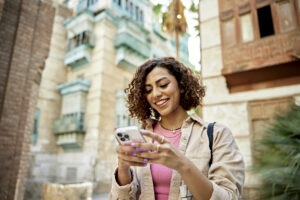 Focused woman using a smartphone, symbolizing the ease of real-time address lookup software for efficient data management and enhanced customer experience.