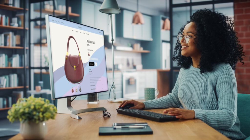 A captivating image of a woman engaged in online shopping on her computer, symbolizing the modern e-commerce experience. This visual represents the convenience and personalization offered by Autoaddress's solutions, as she navigates a user-friendly and customized shopping environment.