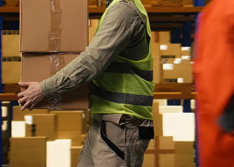 person walking through a warehouse with parcel