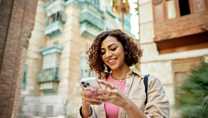 Focused woman using a smartphone, symbolizing the ease of real-time address lookup software for efficient data management and enhanced customer experience.